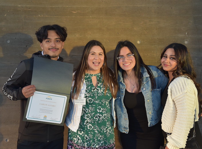 Veronica Mendoza Hand poses with three graduates/students from the Puente program at Mission College.