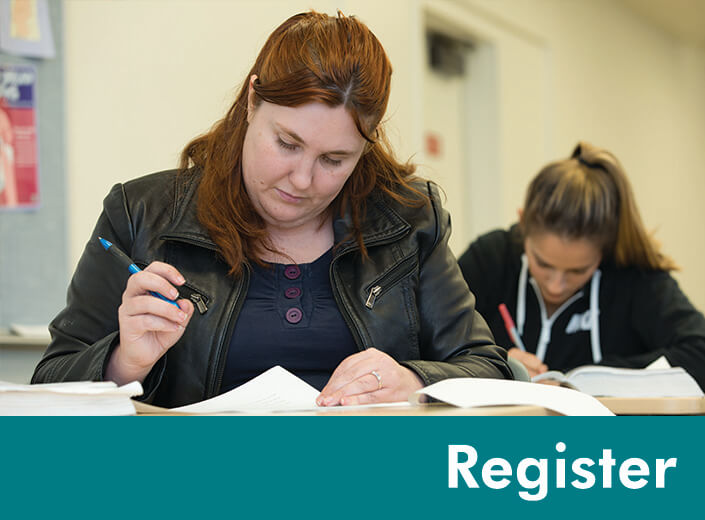 A young woman with shoulder-length brown hair is seated at a desk and is writing on a piece of paper with a pen.The word "register" is written in white text over a strip of teal on the bottom of the graphic.