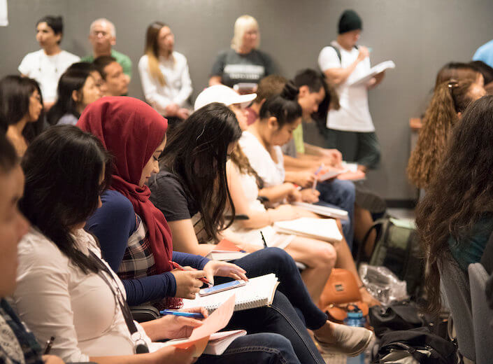 Students at an event (Honors Communication Studies debate) in audience at an event